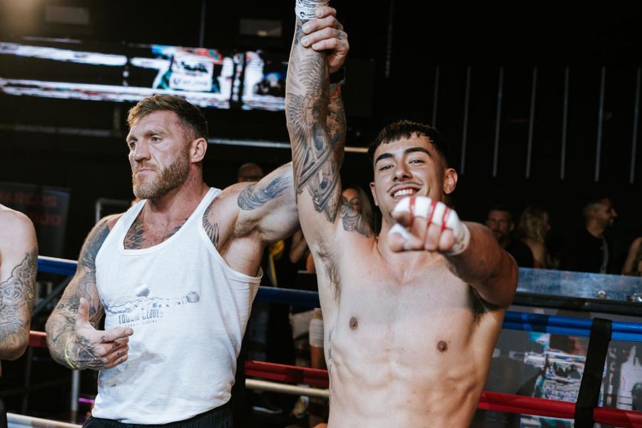 Ellis Harkins with his hand raised in the ring